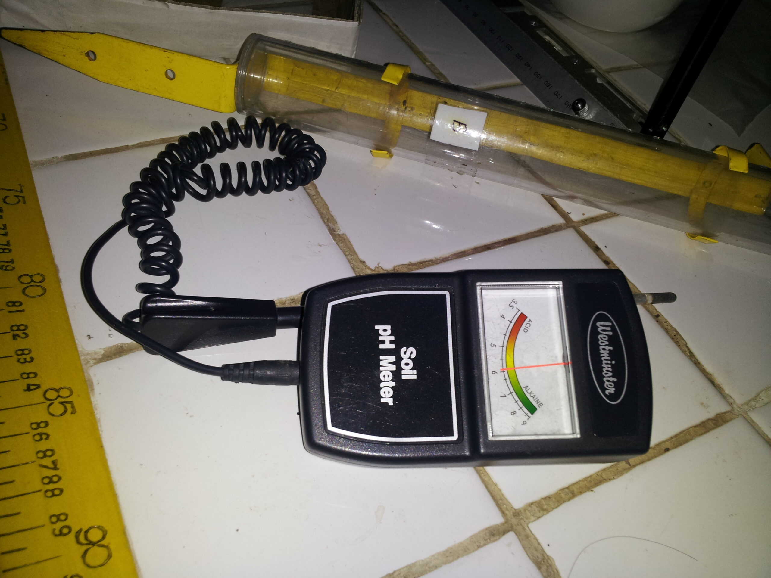 Analog soil pH meter with probe showing acid to alkaline reading scale
