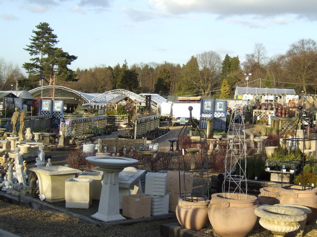 Assorted outdoor terracotta and stone plant pots on display at a garden center