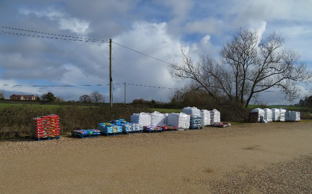 Pallets of bagged potting soil for sale outside a garden center